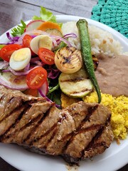 Very Brazilian dish of rice, beans, beef, steak and colorful salad