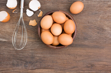 Farm fresh organic eggs laid on a rustic wooden table, top view.
