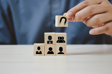 Hand put wooden cubes with Inbound marketing icons and symbols on table and copy space.Business...