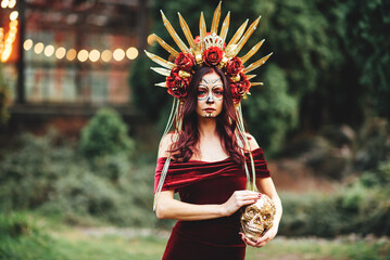 Young woman with painted skull on her face for Mexico's Day of the Dead. portrait of Calavera...
