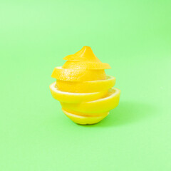Fototapeta na wymiar Minimal composition with bunch of lemon slices on pastel green background.