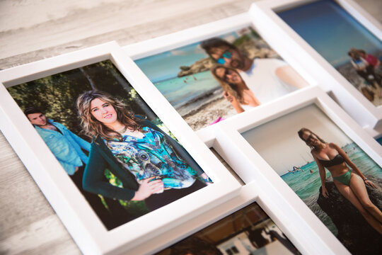 A frame of several photos of a couple in love on their summer vacations, by the beaches of Mallorca. with a gray wooden background.