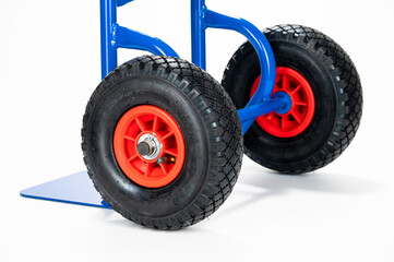 Naklejka premium Wheels and platform of a blue cargo trolley, on the white background