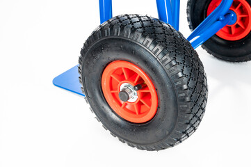 Wheels and platform of a blue cargo trolley, on the white background