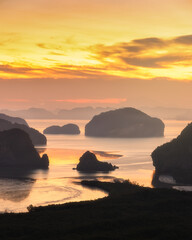 Sunrise at Samed Nang Chee viewpoint, Pang nga, Thailand. Seascape in morning with yellow and orange sky.