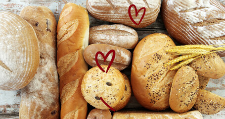 Fototapeta na wymiar Image of falling read hearts over bread