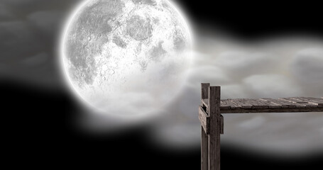 Naklejka premium Image of wooden jetty over full moon and clouds on night sky in background