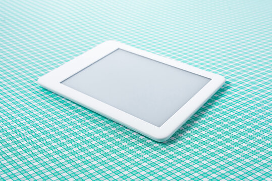 Ebook reader over green striped background