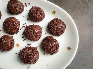Typical brazilian brigadeiros on white plate background and space for text