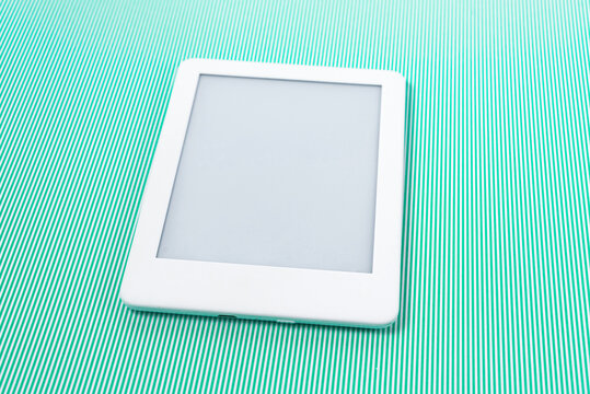 Ebook reader over green striped background