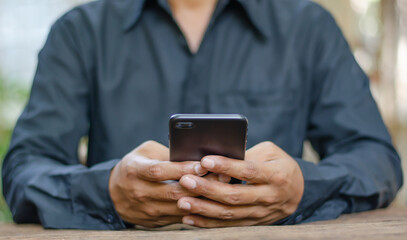 business man use smart phones for check email,look social media,shoppin online,play game,internet banking,pay bill