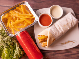 kabab shawarma roll a dish served with salad, raita, sauce and drink top view of indian and...