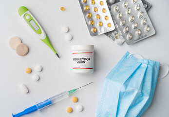 Monkeypox virus disease problem with pills thermometer and facemask