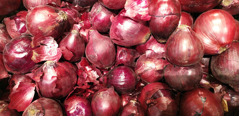 Onions found on the market counter. the concept of the bow. onions on the counter. Background. Red onions