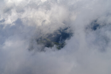 Fog revealing the mountain range in Ligurian Alps, Italy