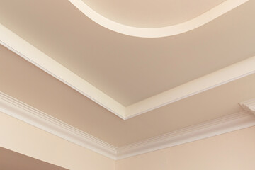 Different  types of angles ceiling skirting made of classic crown moldings. Close-up detail of decoration in interior renovation.