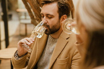 White romantic couple drinking wine during date in cafe