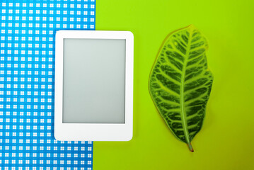 Ebook reader over yellow and blue background