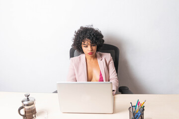 young mexican latin woman working on laptop in office