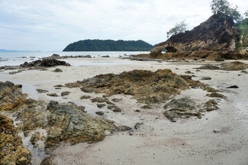 Fototapeta na wymiar Natural strange quartzite coastal rock on the beach.