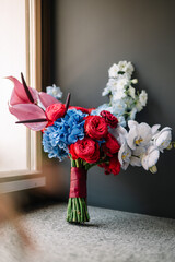 Wedding bouquet of bright fresh flowers on a dark background. . Stylish modern bridal flowers 