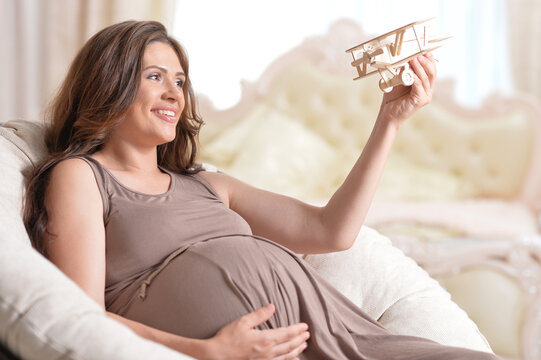 Beautiful pregnant woman posing at home