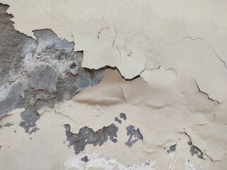Wall fragment with scratches and cracks.Grunge white Abstract wall with peeling paint,close-up background photo texture.Old wall background.Background of old painted wall.Closeup of peeling painted.
