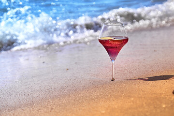 Wine glass with a cocktail by the sea.