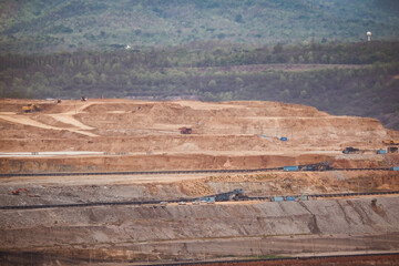 View of Trucks and excavators work in open pits in lignite coal mines. Lignite Coal Extraction...