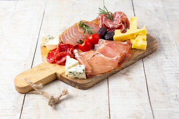 Appetizers table with different antipasti, charcuterie, snacks and cheese. Buffet party. Top view, copy space, negative space