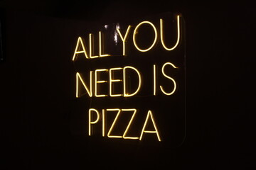 neon light advertisement in pizza restaurant