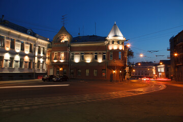 Fototapeta premium Moscow, Russia - July, 27 2014: Historical buildings in Moscow center at night. Mansion on Yauza boulevard. Tram rails and light traces on foreground.