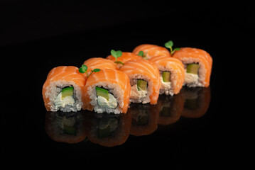 Sushi appetizing on black glossy background roll