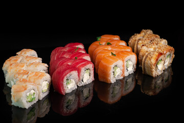 Sushi appetizing on black glossy background roll