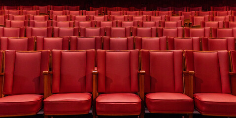 rows of red seats in cinema