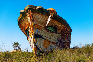 fishing boat wreck front view of keel standing on land with grass