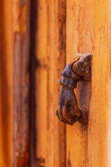knocker on the door in the form of a small hand