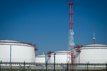 A large oil storage facility with tanks for storing oil and fuel. Storage tank terminal. Selective focus