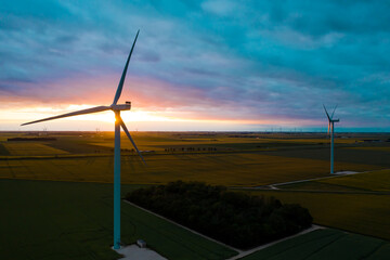 Wind Turbines Windmill Energy. Panoramic view of wind farm or wind park, with high wind turbines...