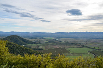 Panoramic view of Alazani valley fields and Caucasus Mountains from the height of the hill, Kakheti region, Georgia 