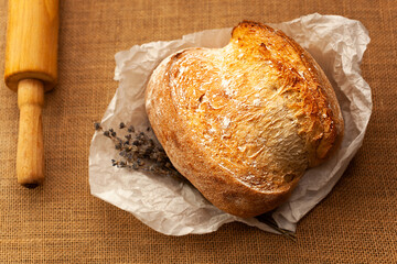 Freshly baked traditional bread. Round-shaped bread with a golden crust. Delicious pastries. Confectionery products.