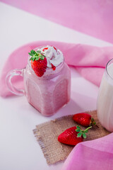decorated strawberry ice cream milkshake with pink color background.different angles view