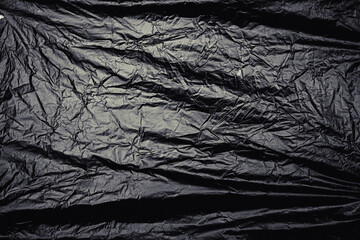 a transparent stretch plastic wrap on black background. realistic plastic wrap texture for overlay...