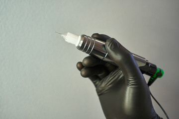 apparatus for permanent makeup in hands in black gloves. tattoo, microblading, permanent makeup