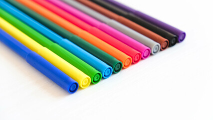 Multicolored felt-tip pens on a white background