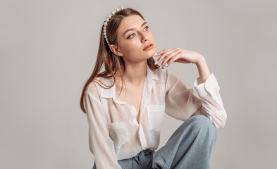 Beautiful model posing reclining head back and holding an elbow on her knee. Active lifestyle.