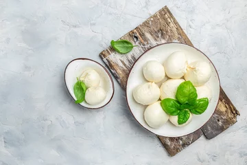 Foto op Plexiglas Cheese collection, white balls of soft Italian cheese mozzarella with fresh basil leaves on a light background. Long banner format. top view © Надія Коваль
