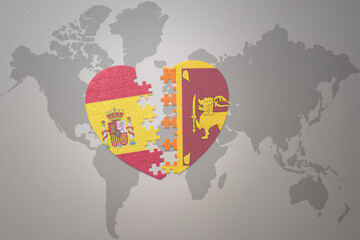 puzzle heart with the national flag of sri lanka and spain on a world map background. Concept.