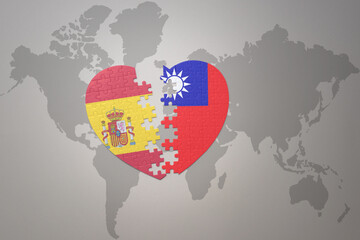 puzzle heart with the national flag of taiwan and spain on a world map background. Concept.