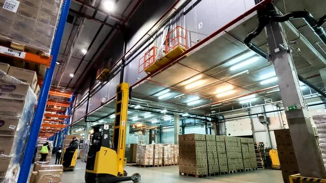Work of special equipment in the warehouse. industrial interior. Forklift work in a warehouse. Modern forklift works in a warehouse. Two-storey modern warehouse.